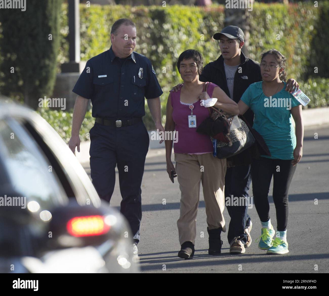 (151203) -- LOS ANGELES, Dec. 3, 2015 -- A survivor (2nd L) of the mass shooting at the Inland Regional Center meets her family after police questioning in San Bernardino City of Southern California, the United States, Dec. 2, 2015. One suspect was gunned down and one in custody Wednesday afternoon after a shooting killed at least 14 people and injured 14 others in San Bernardino, local media reported. ) (zw) U.S.-SAN BERNARDINO-SHOOTING YangxLei PUBLICATIONxNOTxINxCHN   Los Angeles DEC 3 2015 a Survivor 2nd l of The Mass Shooting AT The Domestically Regional Center Meets her Family After Poli Stock Photo