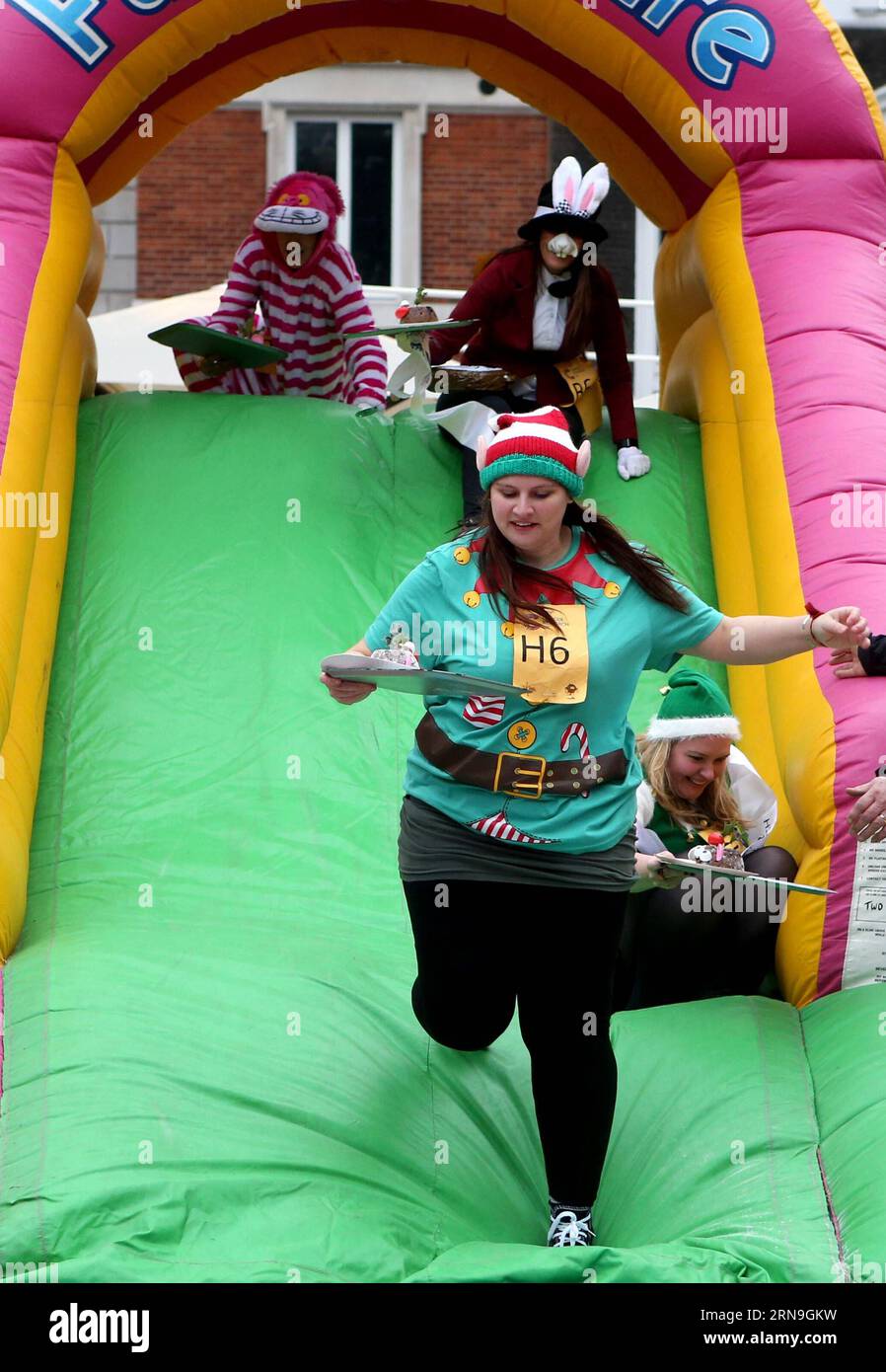 (151205) -- LONDON, Dec. 5, 2015 -- Participants cross the airbed slide in the 35th Great Christmas Pudding Race in a bid to raise money for Cancer Research UK and build up to the festive Christmas season at the Covent Garden in London, Britain, on Dec. 5, 2015. ) BRITAIN-LONDON-35TH GREAT CHRISTMAS PUDDING RACE HanxYan PUBLICATIONxNOTxINxCHN   151205 London DEC 5 2015 Participants Cross The airbed Slide in The 35th Great Christmas Pudding Race in a BID to Raise Money for Cancer Research UK and BUILD up to The Festive Christmas Season AT The Covent Garden in London Britain ON DEC 5 2015 Britai Stock Photo