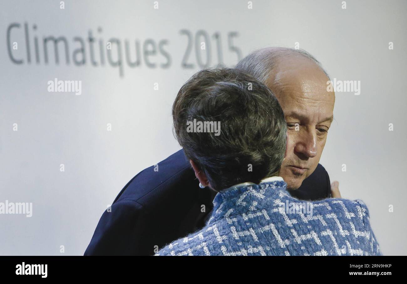 (151207) -- PARIS, Dec. 7, 2015 -- Laurent Fabius (R), French Minister of Foreign Affairs and Chair of the Paris Climate Change Conference (COP21/CMP11), greets Christiana Figueres, executive secretary of the UN Framework Convention on Climate Change (UNFCCC), at a press conference during Paris Climate Change Conference at Le Bourget on the northern suburbs of Paris, France, Dec. 7, 2015. The ministers from all over the world met at the Paris Climate Change Conference, giving final push for the new global climate agreement. The Paris agreement is expected to be the second legally-binding instr Stock Photo