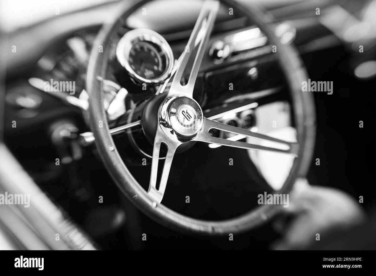 Black and white selective focus photo of a Grant GT steering wheel on an older car in a car show in the Country Club Plaza parking in Sacramento. Stock Photo