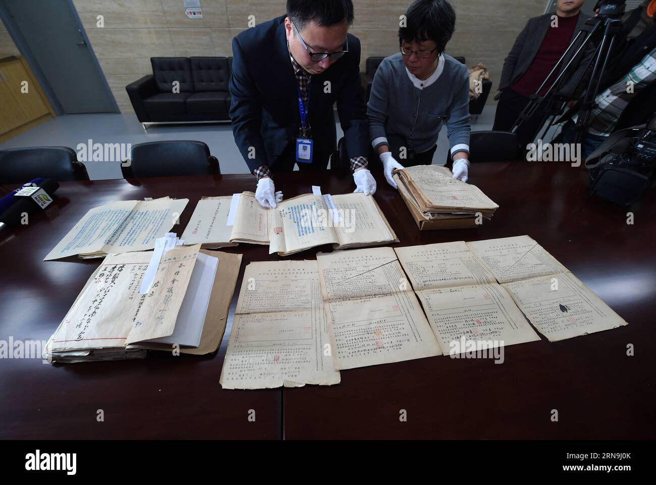 China präsentiert Forschungsergebnisse zum Massaker von Nanking (151208) -- NANJING, Dec. 8, 2015 -- Staff members of the Nanjing Municipal Archives show files of Nanjing Massacre in Nanjing, capital of east China s Jiangsu Province, on Dec. 8, 2015. China has published files from the war crimes investigation into the Nanjing Massacre ahead of the national memorial day for the atrocity. The 15 files are just a small selection of the 2,784 which the Nanjing Provisional Municipal Council compiled between July and November 1946 and which have been listed in the Memory of the World Register by UNE Stock Photo
