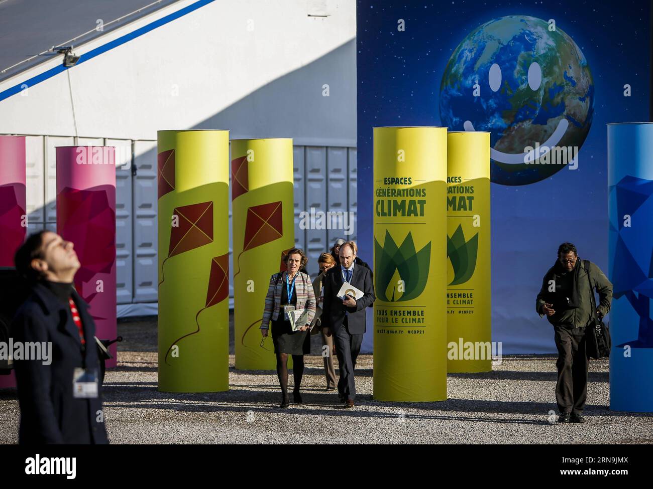 (151209) -- PARIS, Dec. 9, 2015 -- Participants walk at the venue of Paris Climate Change Conference at Le Bourget on the northern suburbs of Paris, France, Dec. 9, 2015. French Foreign Minister and President of Paris Climate Conference Laurent Fabius presented a new clean version of text for a global climate agreement on Wednesday as a basis for further negotiations among countries in the next 48 hours. The main outstanding issues that remain to be resolved include post-2020 climate finance, ambition of action and how to reflect the principle of common but differentiated responsibility in all Stock Photo