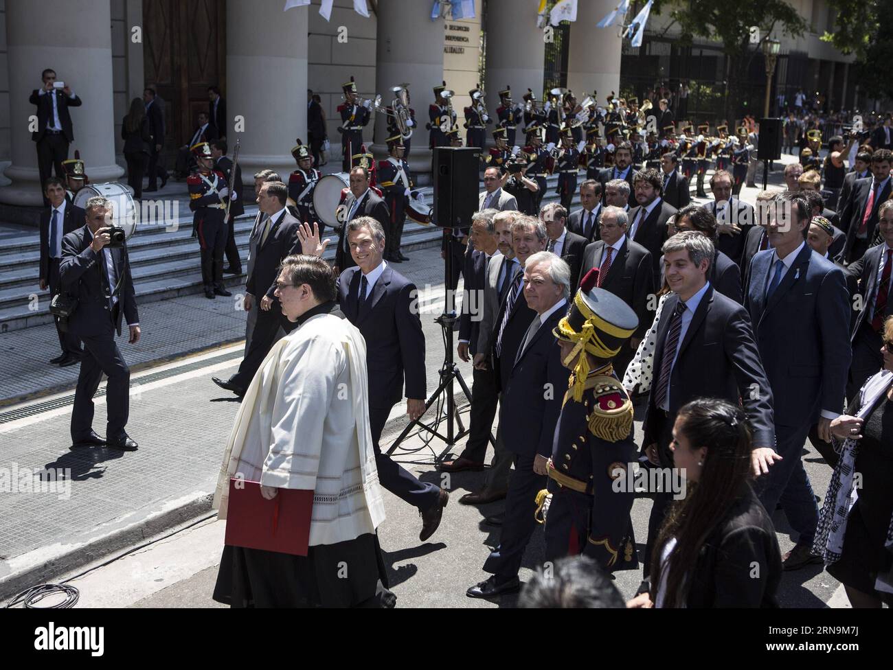 (151211) -- BUENOS AIRES, Dec. 11, 2015 -- Argentina s President Mauricio Macri (C) waves while walking on May Avenue with his Cabinet to participate in the Tedeum at the Metropolitan Cathedral in Buenos Aires, capital of Argentina, Dec. 11, 2015. According to local press, Mauricio Macri Friday attended the traditional religious service at the Metropolital Cathedral, the day after his pesidential inauguration. Martin Zabala) (jg) (fnc) ARGENTINA-BUENOS AIRES-POLITICS-PRESIDENT e MARTINxZABALA PUBLICATIONxNOTxINxCHN   151211 Buenos Aires DEC 11 2015 Argentina S President Mauricio Macri C Waves Stock Photo
