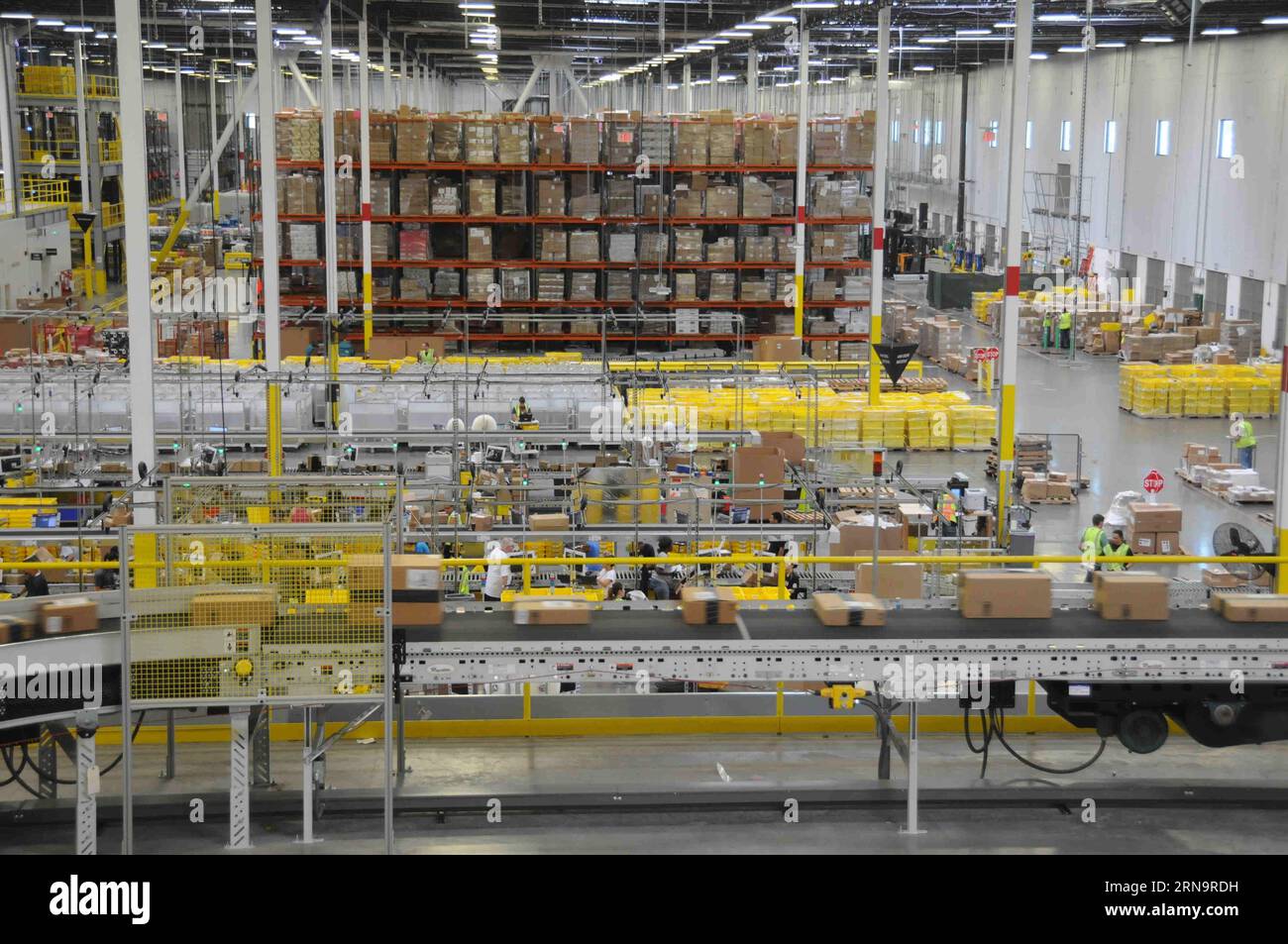 File photo taken on July 16, 2015 shows workers picking customers parcels at the Amazon Fulfillment Center in Tracy, California, the United States. Online retail giant Amazon has attracted many Chinese e-commerce shoppers to purchase foreign goods. As host of the Second World Internet Conference (WIC) that is underway in Wuzhen in east China s Zhejiang Province, China called for global Internet interconnectivity and shared governance by all. As one of the greatest inventions of the 20th century, the Internet has turned the globe into a village and profoundly changed the way people live and do Stock Photo