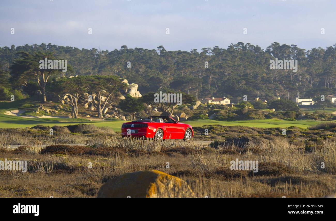 (151217) -- CALIFORNIA, Dec. 17, 2015 -- Photo taken in September 2013 shows a red sports car running on 17-Mile Drive in California, the United States. 17-Mile Drive is widely recognized as one of the most scenic drives in the world. The famous coastal landmark runs through Pacific Grove to Pebble Beach, from the dramatic Pacific coastline to the majestic Del Monte Forest.) U.S.-CALIFORNIA-17-MILE DRIVE-SCENERY YangxLei PUBLICATIONxNOTxINxCHN   151217 California DEC 17 2015 Photo Taken in September 2013 Shows a Red Sports Car RUNNING ON 17 Mile Drive in California The United States 17 Mile Dr Stock Photo