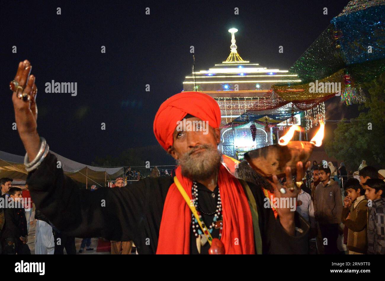 (151220) -- LAHORE, Dec. 19, 2015 -- A Muslim devotee holds an oil lamp as he dances at the shrine of the Sufi saint Mian Mir Sahib during a festival to mark the saint s death anniversary in eastern Pakistan s Lahore, Dec. 19, 2015. Hundreds of devotees are attending the two-day festival. ) PAKISTAN-LAHORE-RELIGIOUS FESTIVAL JamilxAhmed PUBLICATIONxNOTxINxCHN   151220 Lahore DEC 19 2015 a Muslim devotee holds to Oil Lamp As he Dances AT The Shrine of The Sufi Saint Mian me Sahib during a Festival to Mark The Saint S Death Anniversary in Eastern Pakistan S Lahore DEC 19 2015 hundreds of devotee Stock Photo