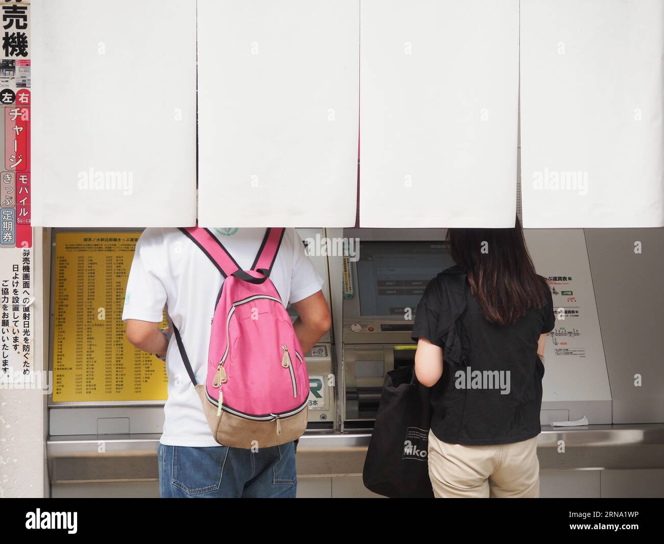 TOKYO, JAPAN August 27, 2023 People using train tickets machines