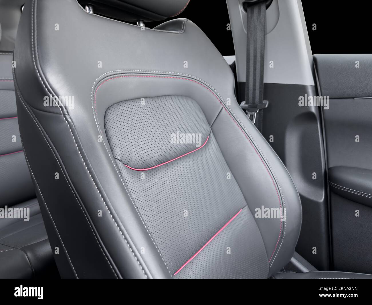 Black luxury modern car Interior. Detail of modern car interior. Part of black leather seats with red stitching in expensive car Stock Photo