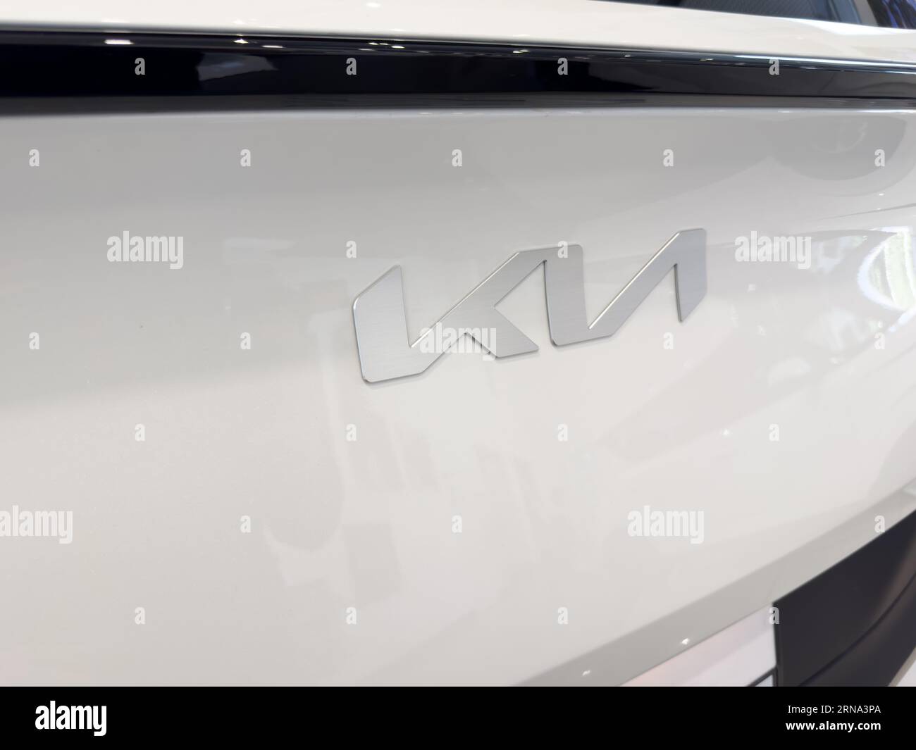 Yerevan, Armenia, June 28, 2023: KIA Motors. New logo on the trunk of white Kia SUV. Chrome KIA logo closes up a trunk Stock Photo