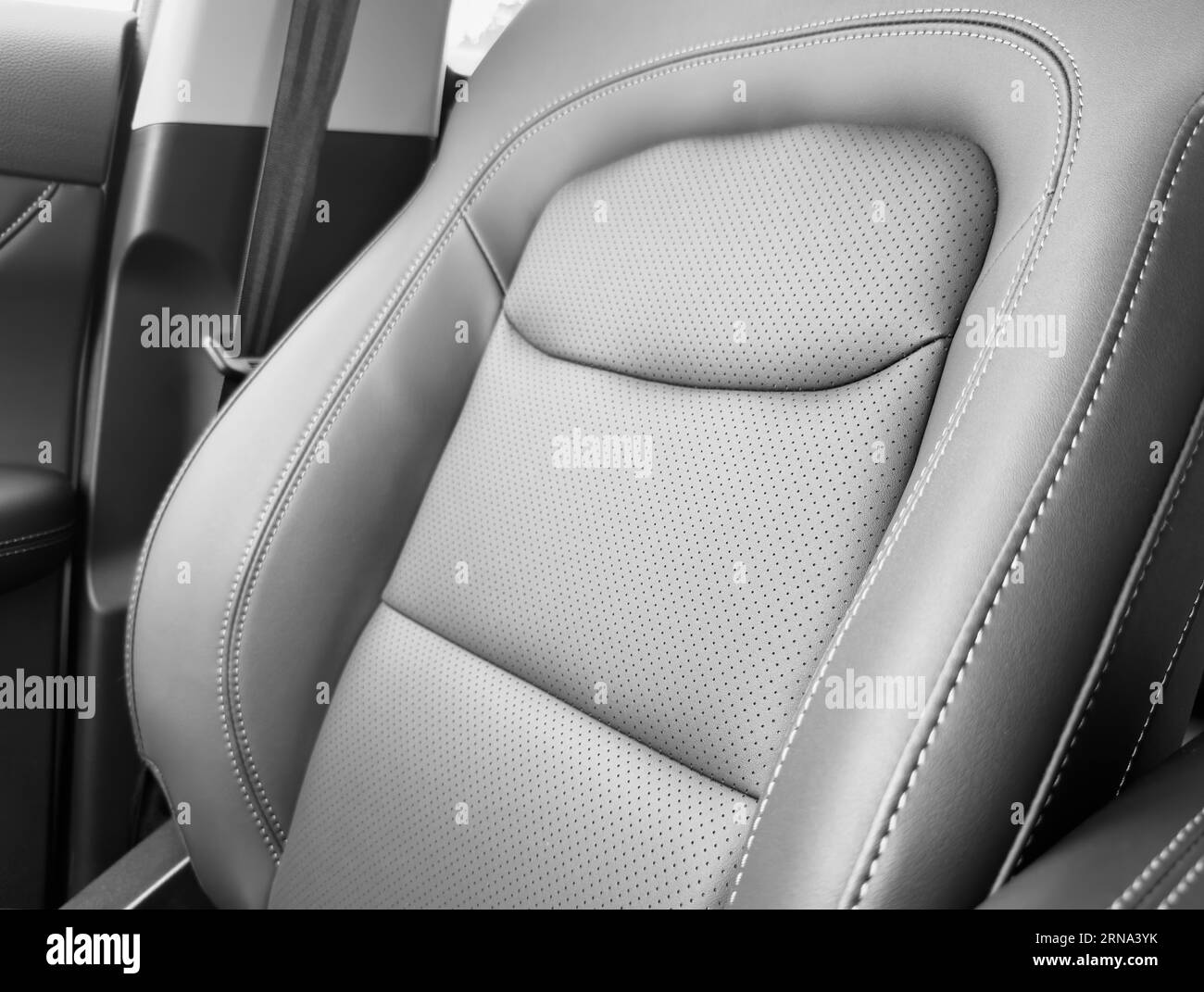 Black luxury modern car Interior. Detail of modern car interior. Part of black leather seats with red stitching in expensive car Stock Photo