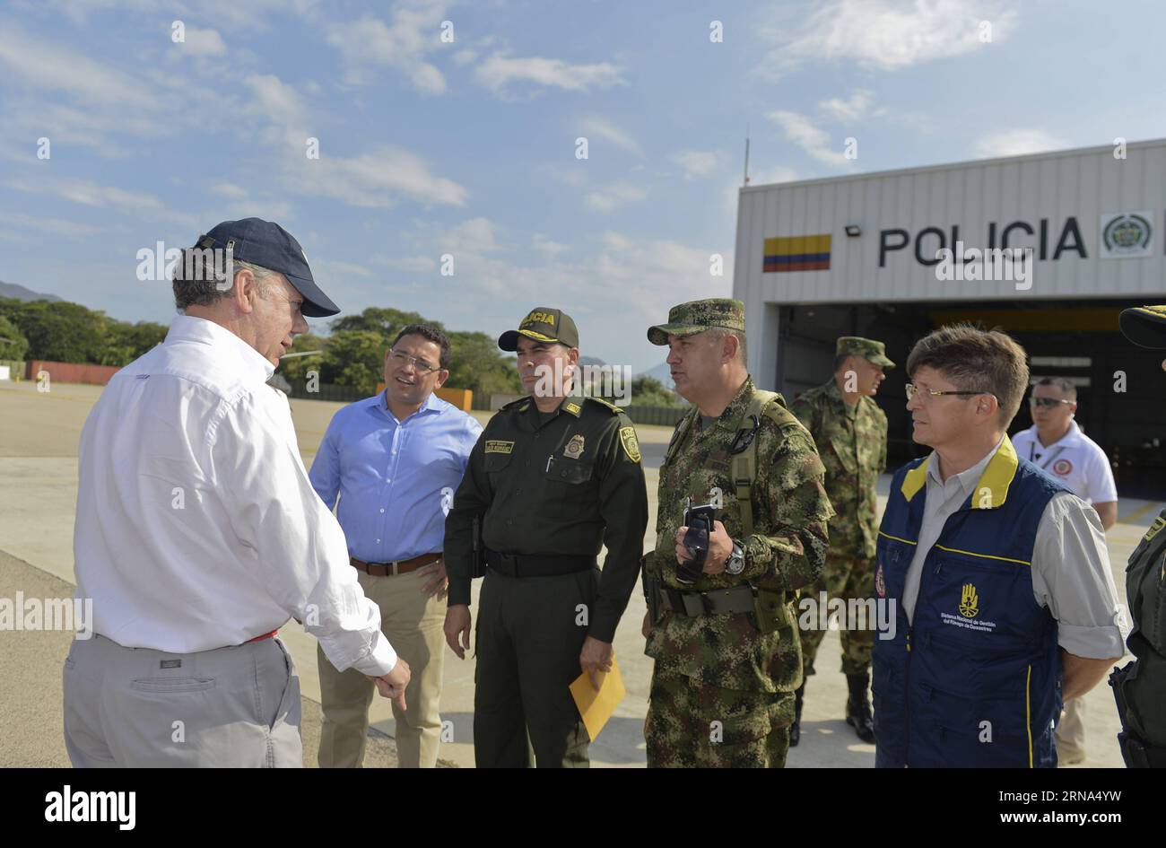 (160106) -- SANTA MARTA, Jan. 6, 2016 -- Image provided by Colombia s Presidency shows Colombian President Juan Manuel Santos (1st L) being received by the Santa Marta Mayor Rafael Alejandro Martinez (2nd L), region Police and Army Commanders, and the Director of the Unit for Disaster Risk Management (UNGRD, for its acronym in Spanish) Carlos Ivan Marquez Perez (1st R), prior the meeting of pursuit the plans to face El Nino Phenomenon, in Santa Marta, Colombia, Jan. 6, 2016. Colombian President Juan Manuel Santos led the meeting in which the plans to face El Nino Phenomenon were evaluated, and Stock Photo