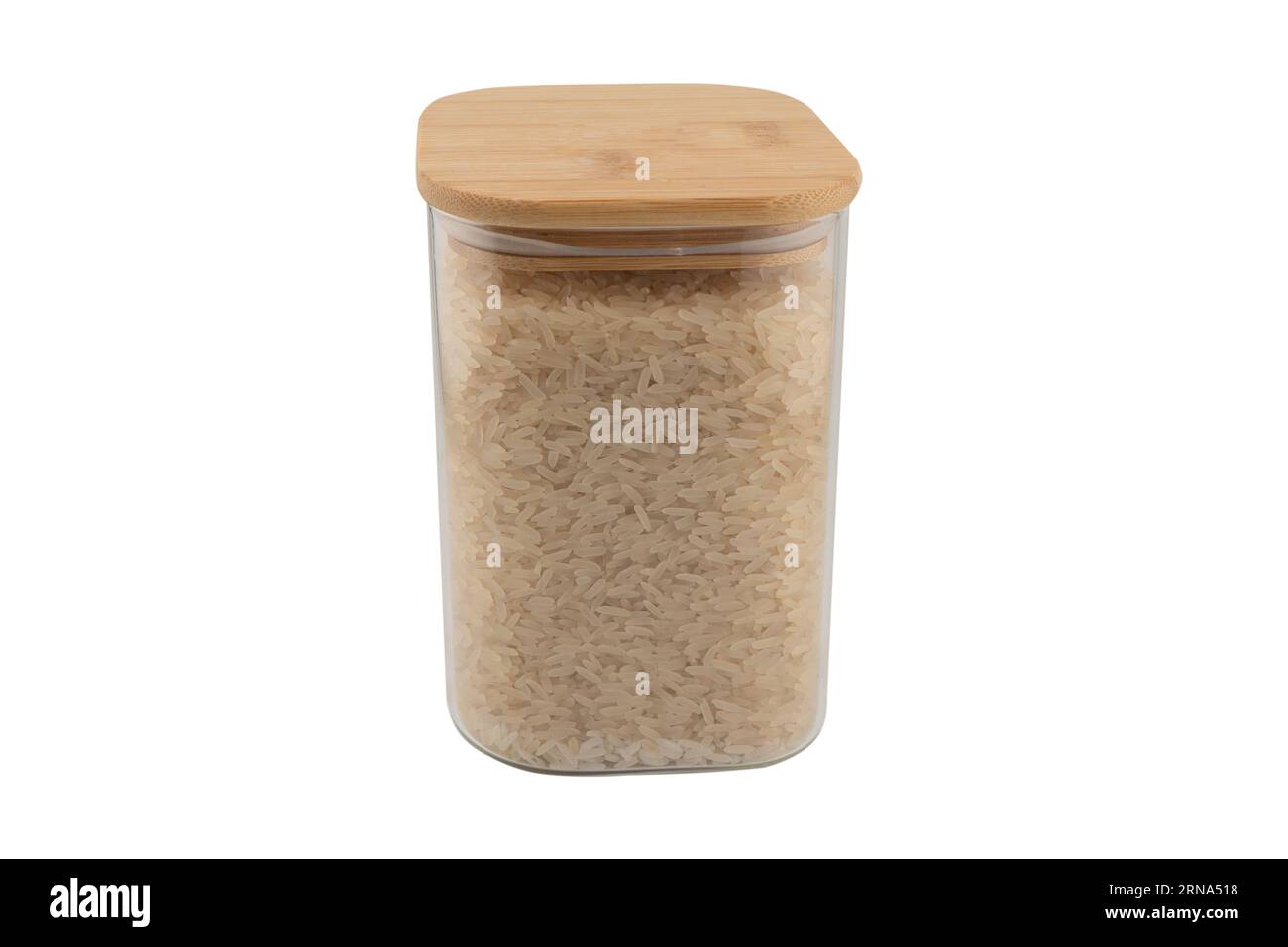 Rice in a glass jar isolated on a white background. Raw white organic