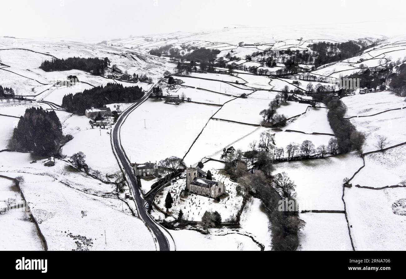 File photo dated 28/11/2021 of snow covering fields and hills surround St Mary The Virgin Church in the Arkengarthdale, North Yorkshire. The compensation cap for households and businesses that lose power in severe weather has increased from £700 to £2,000 after 'lessons learnt' in the aftermath of Storm Arwen. Under Ofgem's new rules, the initial payment will also increase, from £70 to £80, if a customer's supply is not restored after 24 hours in a category one storm or 48 hours in a category two storm. Issue date: Friday September 1, 2023. Stock Photo