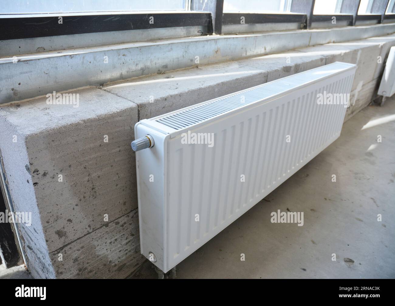 Close up on hot water radiator installation Stock Photo - Alamy