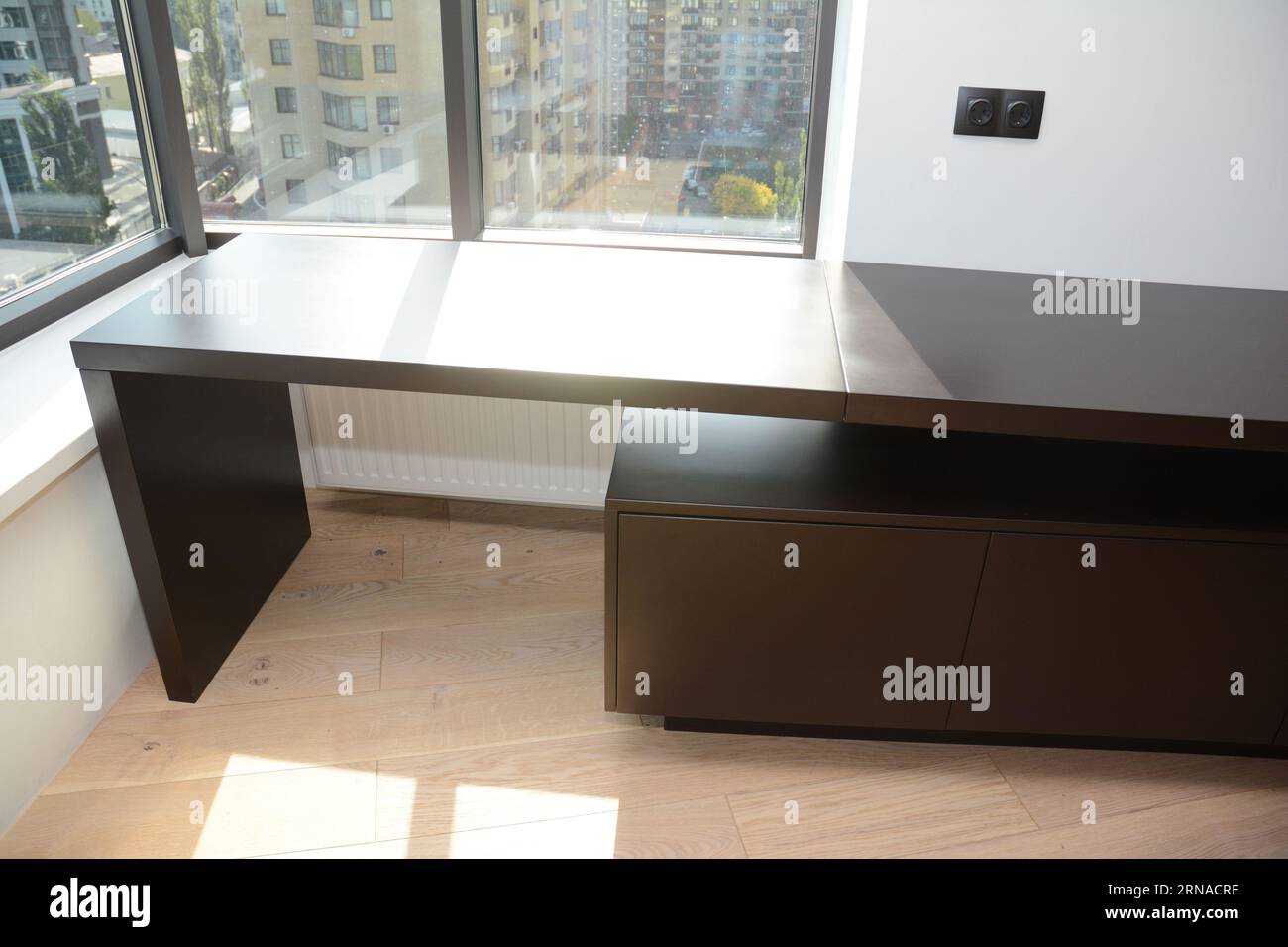 Empty wooden table in the room with wooden floor and window view  in high-rise apartments Stock Photo