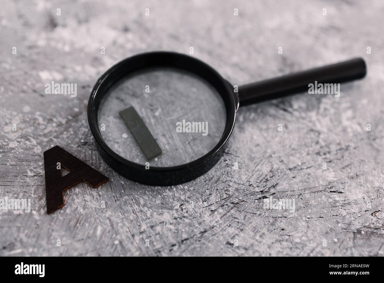 AI text with magnifying glass analysing the I for intelligence, concept ...