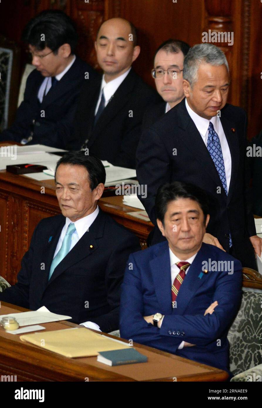 (160122) -- TOKYO, Jan. 22, 2016 -- Japan s Economy and Fiscal Policy Minister Akira Amari (top R) walks behind Prime Minister Shinzo Abe (bottom R) during a session of the House of Representatives in Tokyo, Japan, on Jan. 22, 2016. Japanese Prime Minister Shinzo Abe sought to gain more votes from lower income class for the upcoming upper house election by vowing to address wage gaps in his policy speech on Friday. ) JAPAN-TOKYO-ABE-POLICY SPEECH MaxPing PUBLICATIONxNOTxINxCHN   160122 Tokyo Jan 22 2016 Japan S Economy and Fiscal Policy Ministers Akira Amari Top r Walks behind Prime Ministers Stock Photo