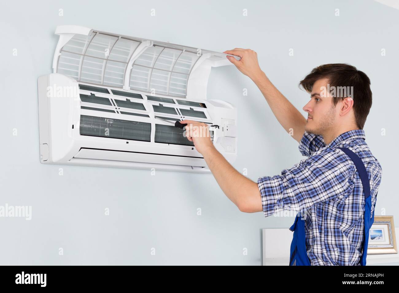 Engineer servicing air conditioner hi-res stock photography and images ...