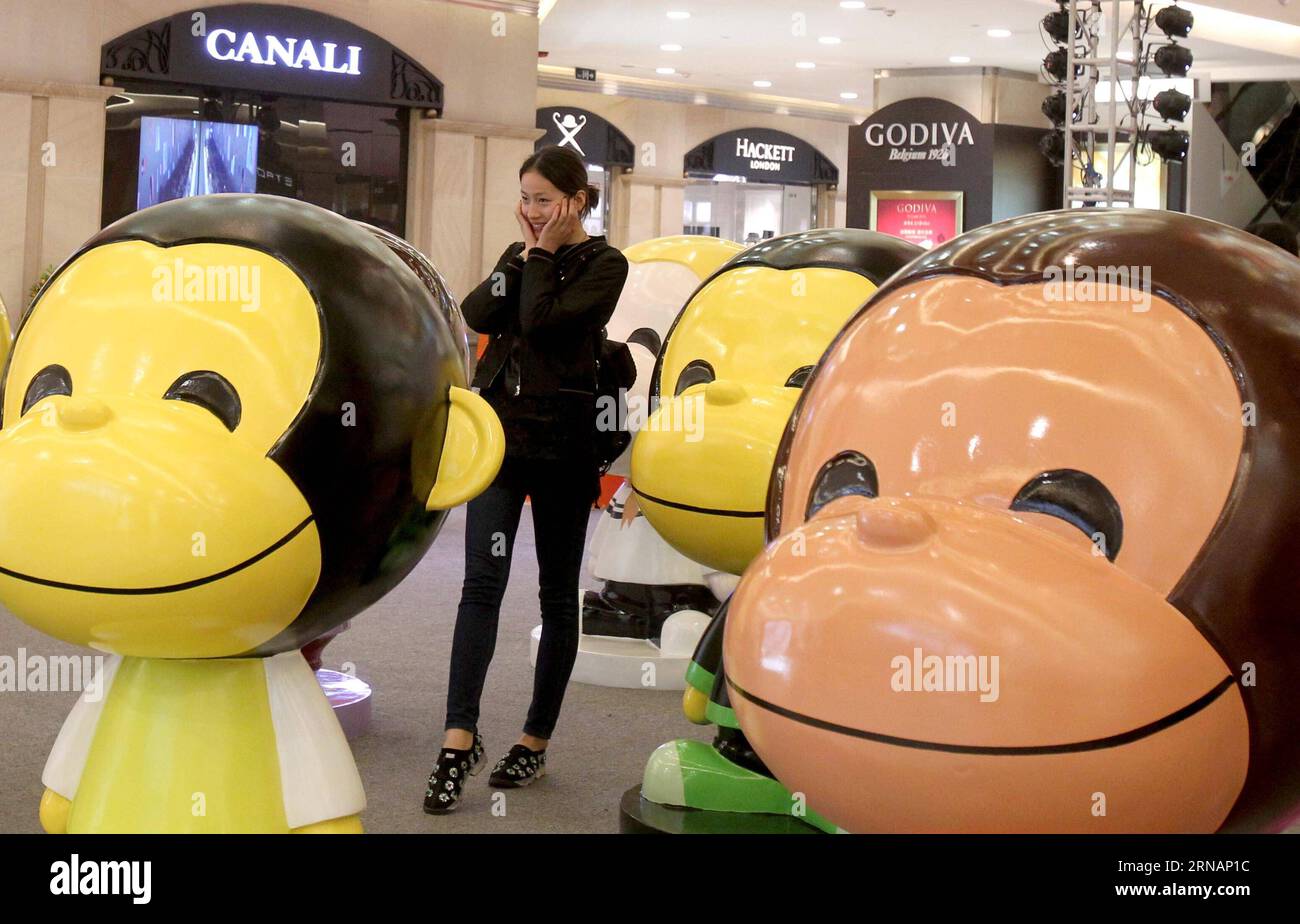 (160203) -- SHANGHAI, Feb. 3, 2016 -- A girl poses for a photo among monkey figurines at the Westgate Mall on the Nanjing West Road in Shanghai, east China, Feb. 3, 2016. A total of 100 lovely monkey figurines have been placed on the Nanjing West Road, a prosperous commericial street, in Shanghai, to create a New Year atmosphere. ) (lfj) CHINA-SHANGHAI-MONKEY FIGURINES (CN) LiuxYing PUBLICATIONxNOTxINxCHN   Shanghai Feb 3 2016 a Girl Poses for a Photo among Monkey Figurines AT The West Gate Mall ON The Nanjing WEST Road in Shanghai East China Feb 3 2016 a total of 100 Lovely Monkey Figurines h Stock Photo