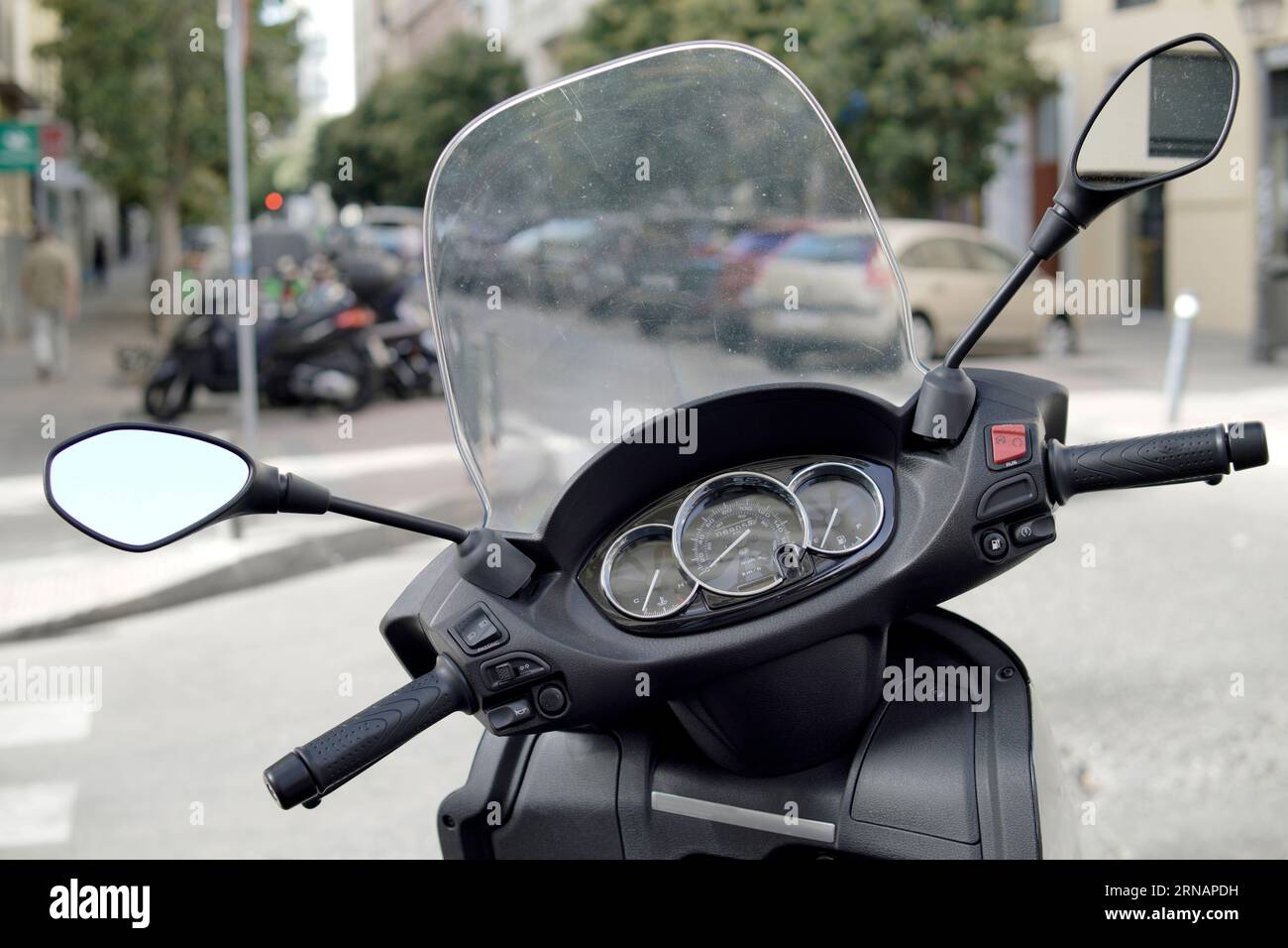part of motorcycle with windshield in the street Stock Photo