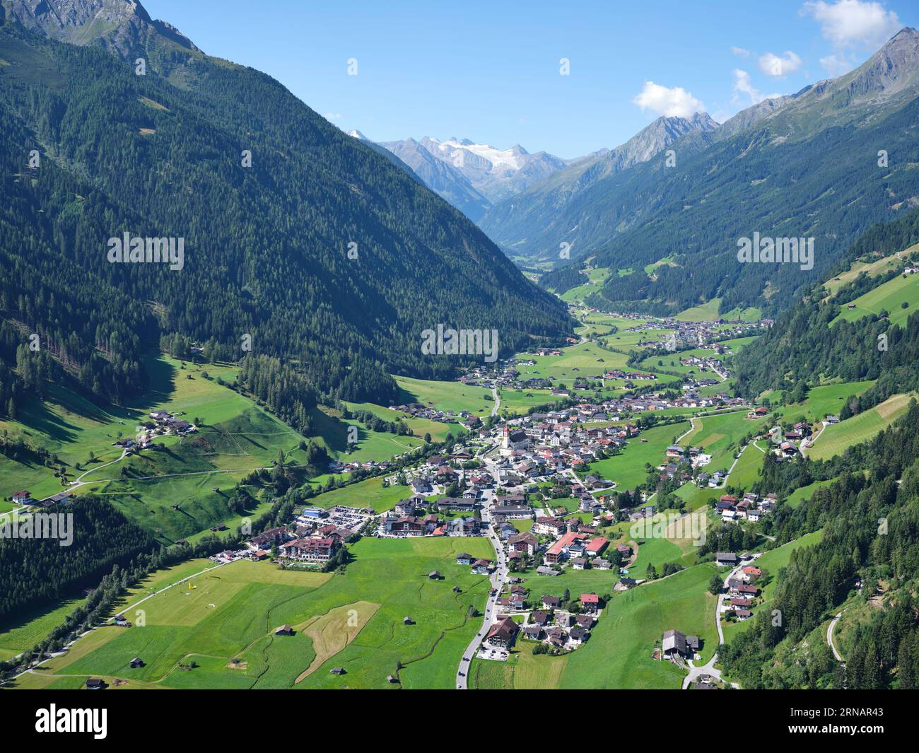AERIAL VIEW. The Stubai Valley with Neustift im Stubaital and, in the distance, the Zuckerhütl (3507m) and the Sulzenauferner glacier. Tyrol, Austria. Stock Photo
