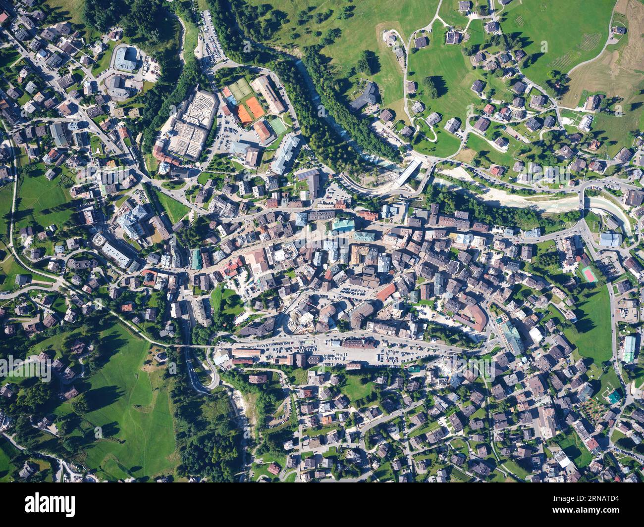 VERTICAL AERIAL VIEW. The city center of Cortina d'Ampezzo on the left bank of the Boite River. Province of Belluno, Veneto, Italy. Stock Photo