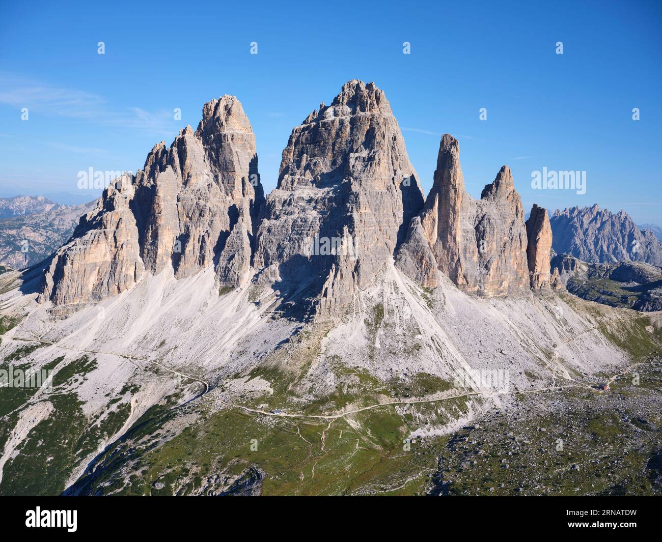 AERIAL VIEW. The south-facing side of the iconic Tre Cime di Lavaredo (elevation: 2999 meters). Auronzo di Cadore, Province of Belluno, Veneto, Italy. Stock Photo