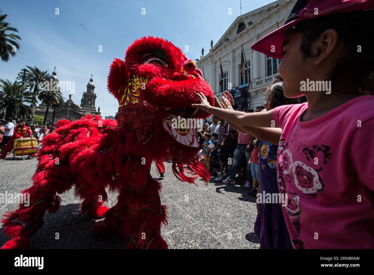 Children interact with a Chinese lion during the Chinese Lunar New Year and the Feast of Santiago celebrations, at the Plaza de Armas in Santiago, capital of Chile, on Feb. 12, 2016. Feast of Santiago celebrates the 475th anniversary of the founding of the Chilean capital of Santiago by Pedro de Valdivia. Jorge Villegas) (jg) (fnc) CHILE-SANTIAGO-CHINA-LUNAR NEW YEAR e JORGExVILLEGAS PUBLICATIONxNOTxINxCHN   Children interact With a Chinese Lion during The Chinese Lunar New Year and The Feast of Santiago celebrations AT The Plaza de Armas in Santiago Capital of Chile ON Feb 12 2016 Feast of Sa Stock Photo