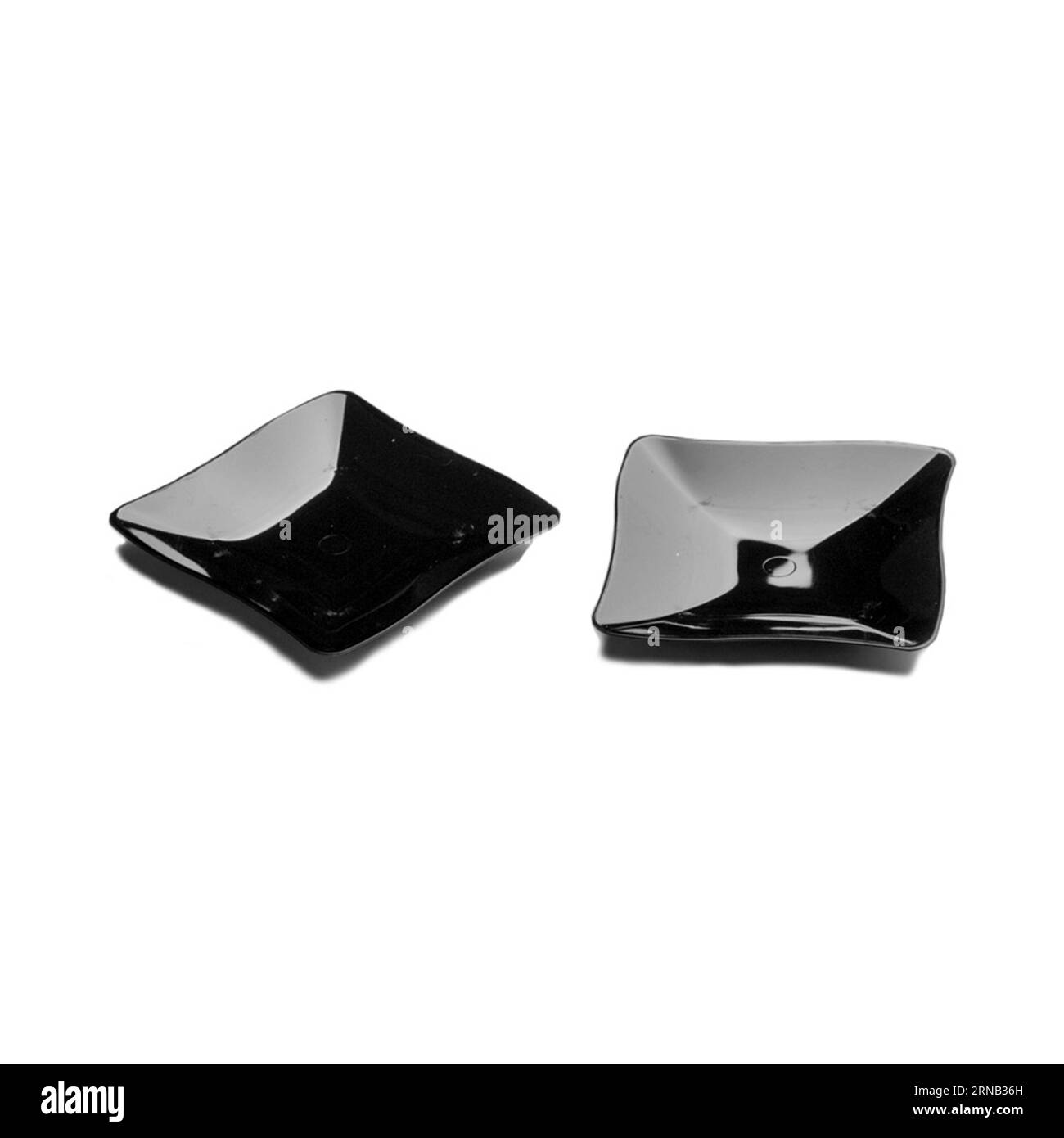 Two black plastic dessert plates isolated over white background