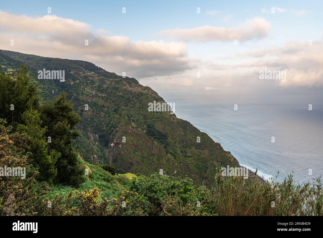 Atlantic Ocean with steep partly rocky hills above in northwestern coast of Madeira island near Porto Moniz - view from Ponta da Ladeira viewpoint dui Stock Photo
