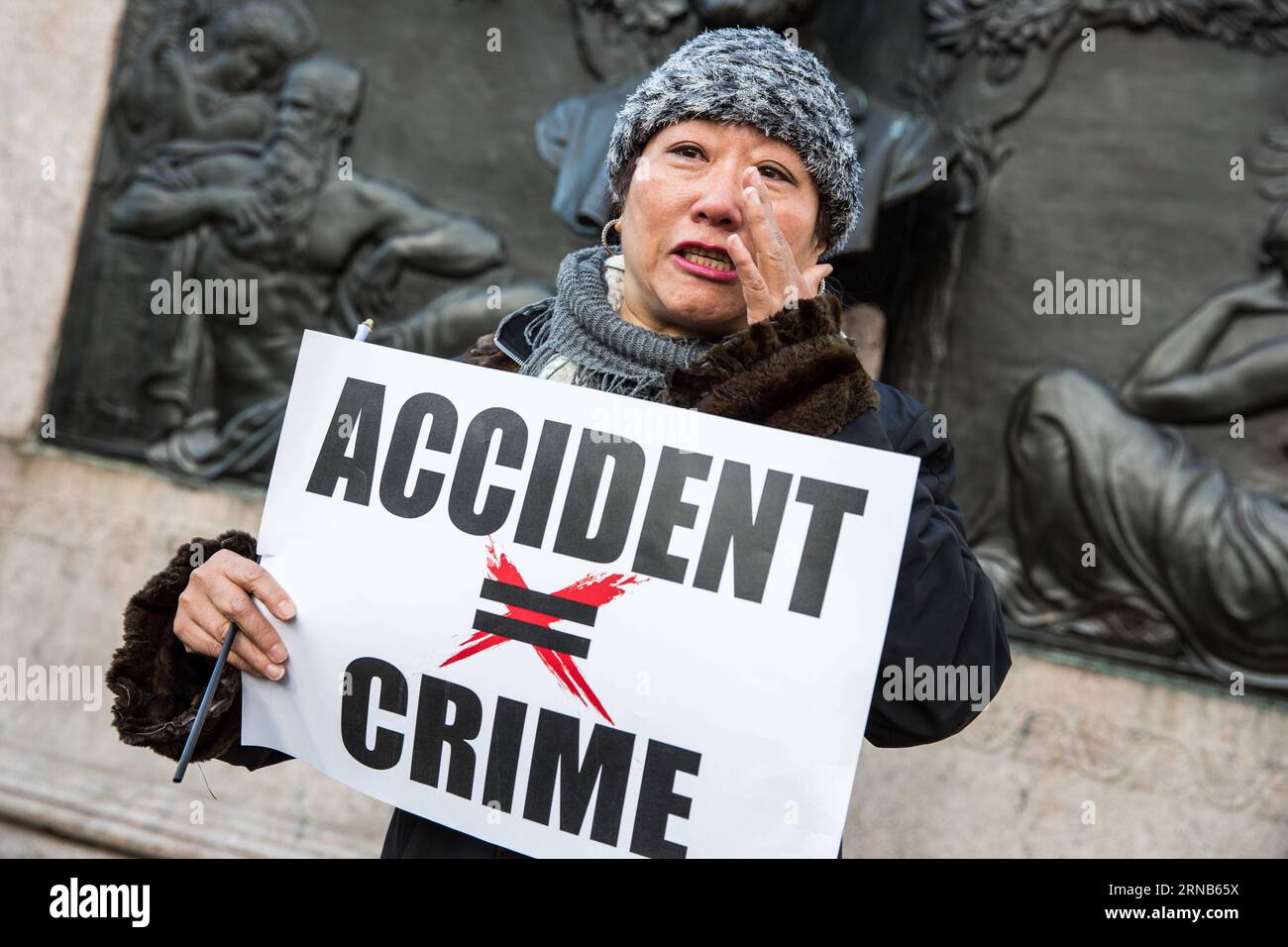 A woman in tears speaks to the press during a rally in support of New York City Police officer Peter Liang, at Brooklyn s Cadman Plaza Park, in New York, the United States, Feb. 20, 2016. Peter Liang, a New York City police officer of Chinese descent, was found guilty on Feb. 11 of manslaughter over the shooting of a black man, prompting concerns of discrimination. On Nov. 20, 2014, Liang, a 27-year-old with only a year and a half on the job, was patrolling with his partner in Brooklyn s East New York housing project when he was startled by a noise. In a stairway that prosecutors described as Stock Photo