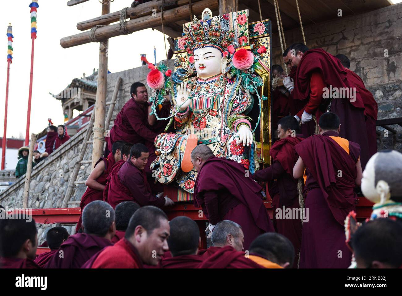 XINING, Feb. 22, 2016 -- Several Buddhists pull butter sculptures to a platform at Taer Monastery in Huangzhong County of northwest China s Qinghai Province, Feb. 22, 2016. An exhibition of butter sculptures was held on Monday at Taer Monastery, which is the birth place of Tsongkhapa, founder of the Geluk school of Tibetan Buddhism. ) (dhf) CHINA-QINGHAI-TAER MONASTERY-BUTTER SCULPTURE (CN) WuxGang PUBLICATIONxNOTxINxCHN   Xining Feb 22 2016 several Buddhists pull Butter Sculptures to a Platform AT Taer monastery in Huang Zhong County of Northwest China S Qinghai Province Feb 22 2016 to Exhibi Stock Photo