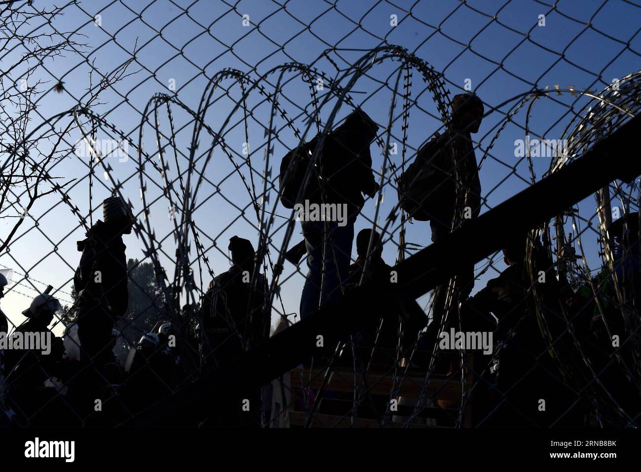 Afghan migrants protest and stand behind the wire fencing at the closed Greek-Macedonian border, near the Macedonian city of Gevgelija on Feb. 23, 2016. Macedonia has confirmed that it only allowed Syrian and Iraqi refugees through, matching a decision by its northern neighbor, Serbia. Around 5,000 migrants were waiting at the border wishing to continue their journey across Macedonia, Serbia, Croatia, Slovenia and then Austria, with Germany the final goal for most. MACEDONIA-GEVGELJA-MIGRANTS Biljana, PUBLICATIONxNOTxINxCHN   Afghan Migrants Protest and stand behind The Wire fencing AT The Clo Stock Photo