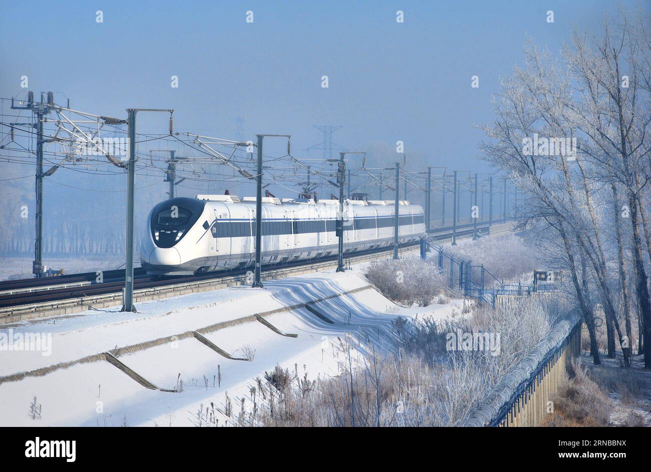 File photo taken on Feb. 14, 2015 shows a CRH2G bullet train running for a test on the Harbin-Dalian high-speed railway, northeast China. Building more high-speed railways has been a hot topic at the annual sessions of China s provincial legislatures and political advisory bodies intensively held in January. China has the world s largest high-speed rail network, with the total operating length reaching 19,000 km by the end of 2015, about 60 percent of the world s total. The expanding high-speed rail network is offering unprecedented convenience and comfort to travelers, and boosting local deve Stock Photo