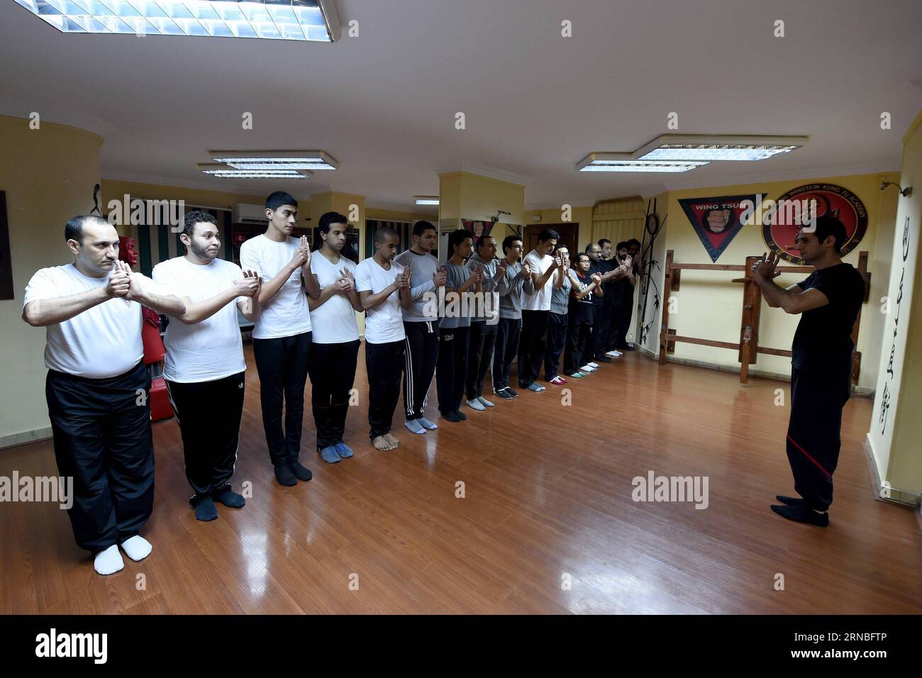 WT Kampfsportschule in Kairo (160304) -- CAIRO, March 4, 2016 -- Mohamed Noah and his Wing Tsun students salute each other before a class at Egypt Wing Tsun Academy, Cairo, Egypt on March 1, 2016. Wing Tsun started to become more popular in Egypt as it is a simple martial art for self-defense that requires neither effort nor physical strength, said trainer Mohamed Noah, or Sifu as his students call him, at the small Wing Tsun academy in Maadi district south of the capital Cairo. Located in the first floor of a building in a quiet street, Egypt Wing Tsun Academy, the only officially certified C Stock Photo