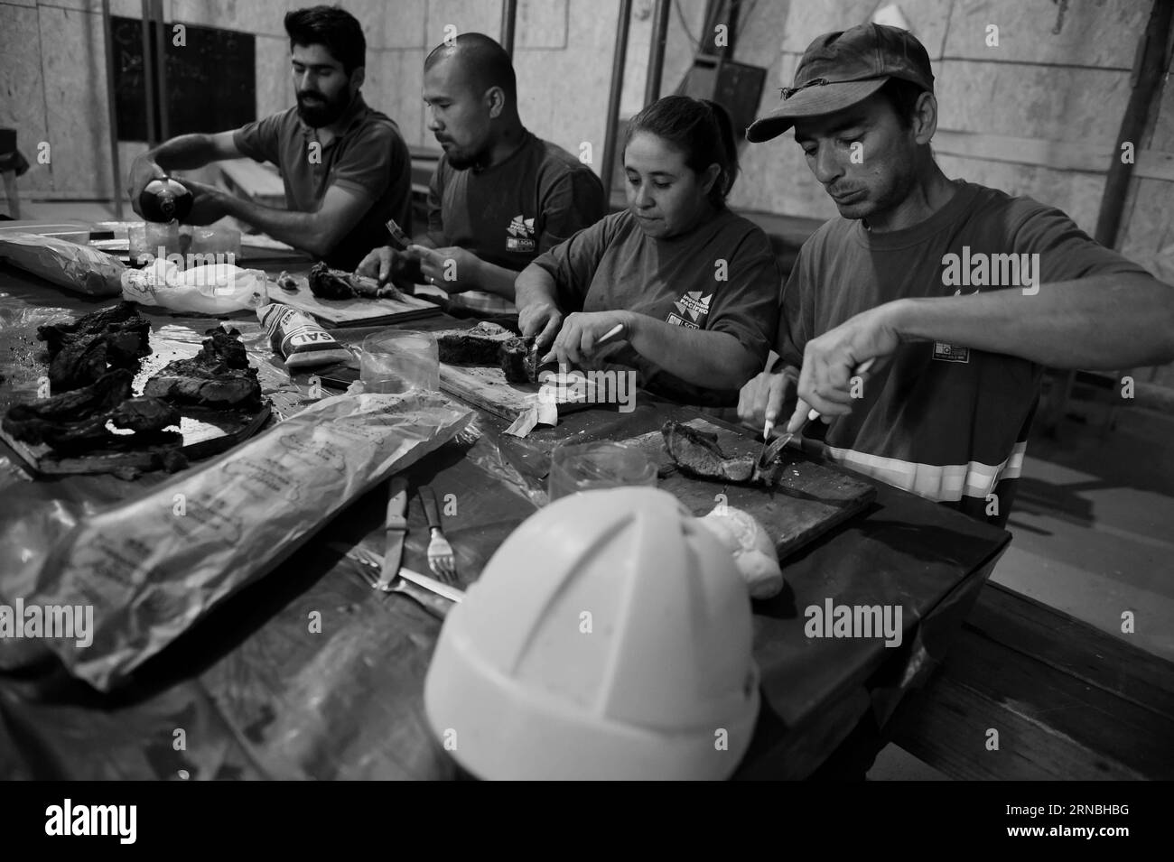 MONTEVIDEO, March 4, 2016 -- Claudia Barreto has a lunch with her colleagues during their break at a factory in Montevideo, capital of Uruguay, on March 4, 2016. Claudia, 44 years old, is the mother of 5 children and works as construction bricklayer since 2008 to support her family. She is the only female at a factory with about 50 workers and has the similar workload with others. According to the new added clauses in documents of the Only National Union of Construction and Annexes (SUNCA), companies are required to hire more female staff. The International Women s Day is celebrated annually o Stock Photo