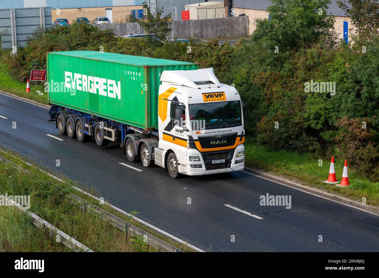 VKVP Haulage MAN lorry Evergreen container, A12 dual carriageway main road, Martlesham, Suffolk, England, UK Stock Photo