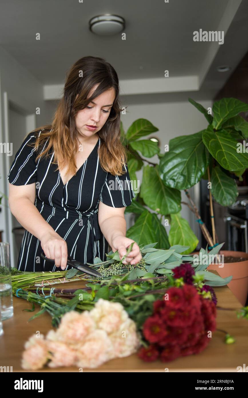 Young woman cutting flowers Stock Photo
