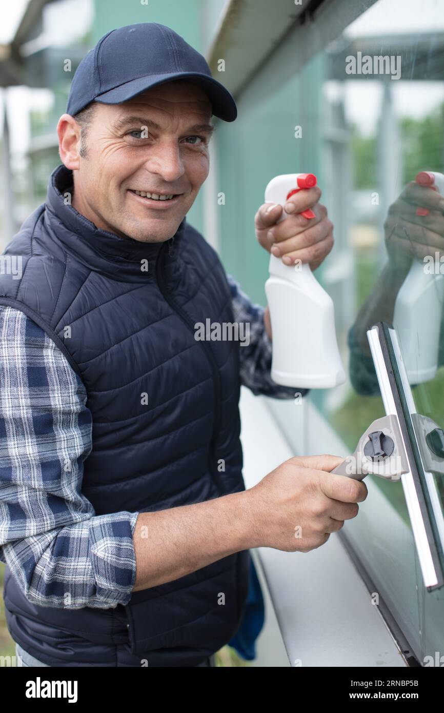 professional window cleaner soaps and squeegies a window clean Stock