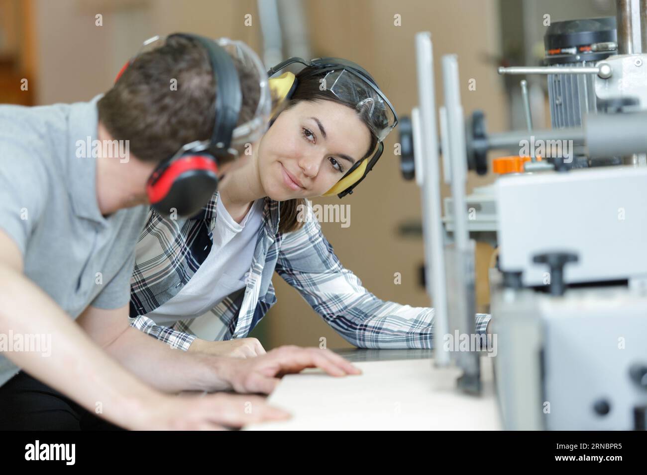 carpenter training female apprentice to use tools Stock Photo Alamy