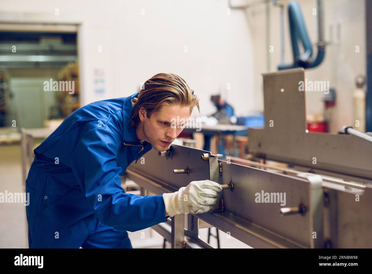 Concentrated worker fixing metal construction Stock Photo