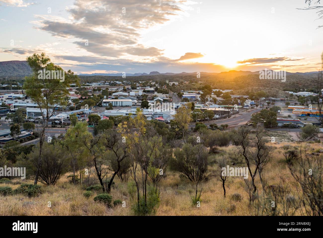 Looking west into the setting sun over the town of Alice Springs (Mparntwe) from ANZAC Hill in the Northern Territory of Australia Stock Photo