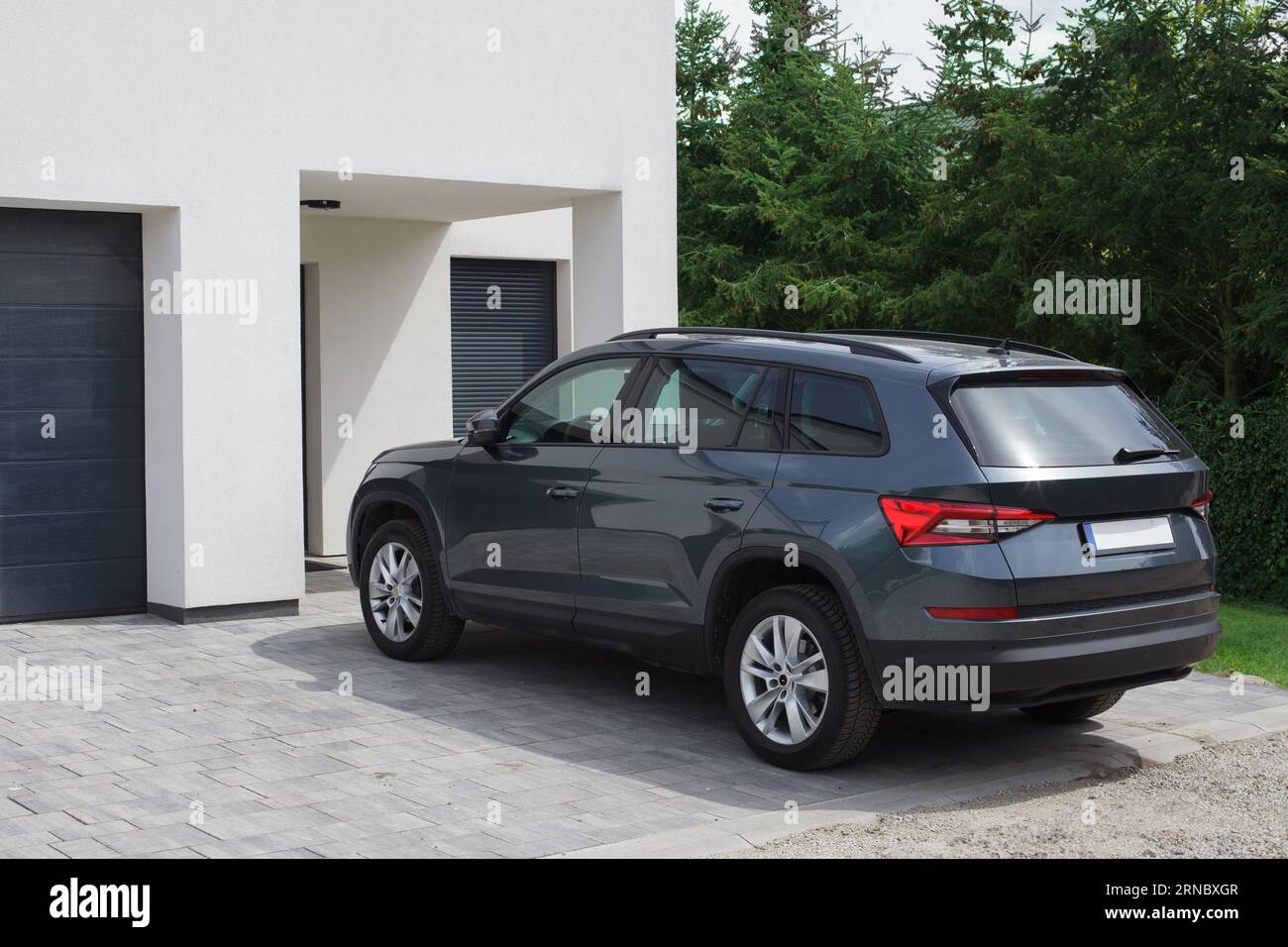 A crossover car parked in front of the family home. Stock Photo