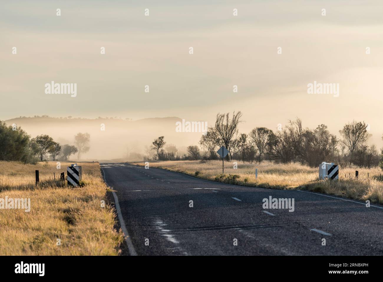 Low-hanging mist over the Larapinta Drive between Alice Springs (Mparntwe) and Simpsons Gap (Rungutjirpa) in the Northern Territory of Australia Stock Photo