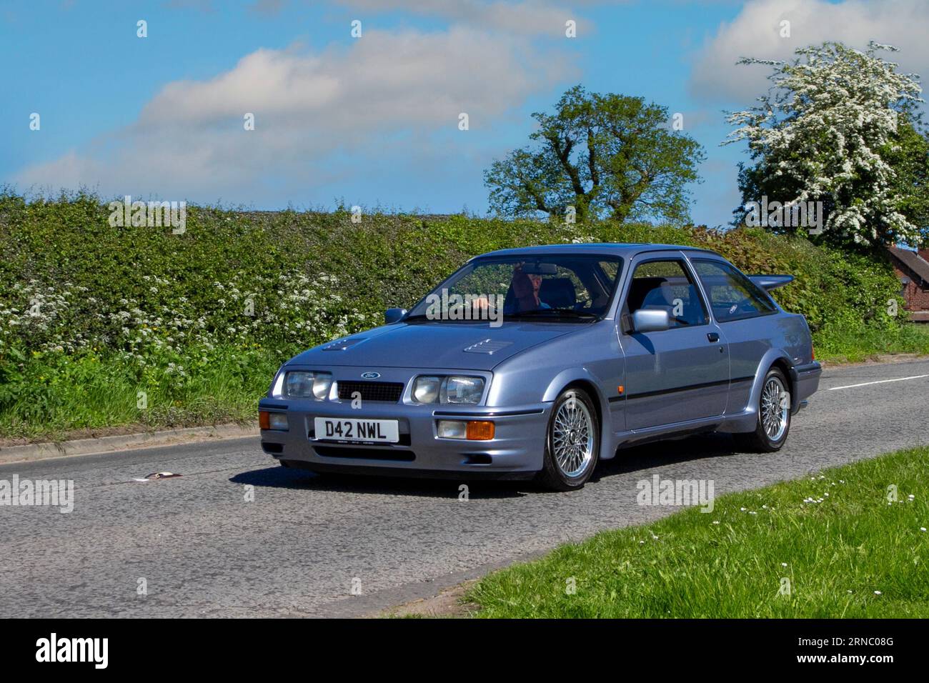 1986 80s eighties Ford Sierra Rs Cosworth Blue Car Hatchback Petrol 1993 cc en-route to Capesthorne Hall classic car show, Cheshire, UK Stock Photo