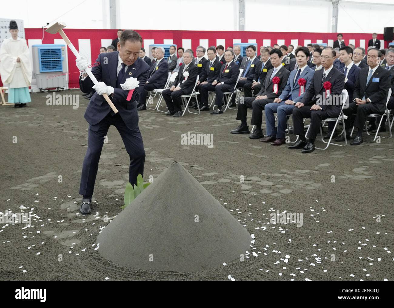Atsuyoshi Koike, president of semiconductor venture Rapidus Corp., breaks  ground during a ceremony in Chitose in Hokkaido, northern Japan, on Sept.  1, 2023. The Japanese government-subsidized chip venture was set up by