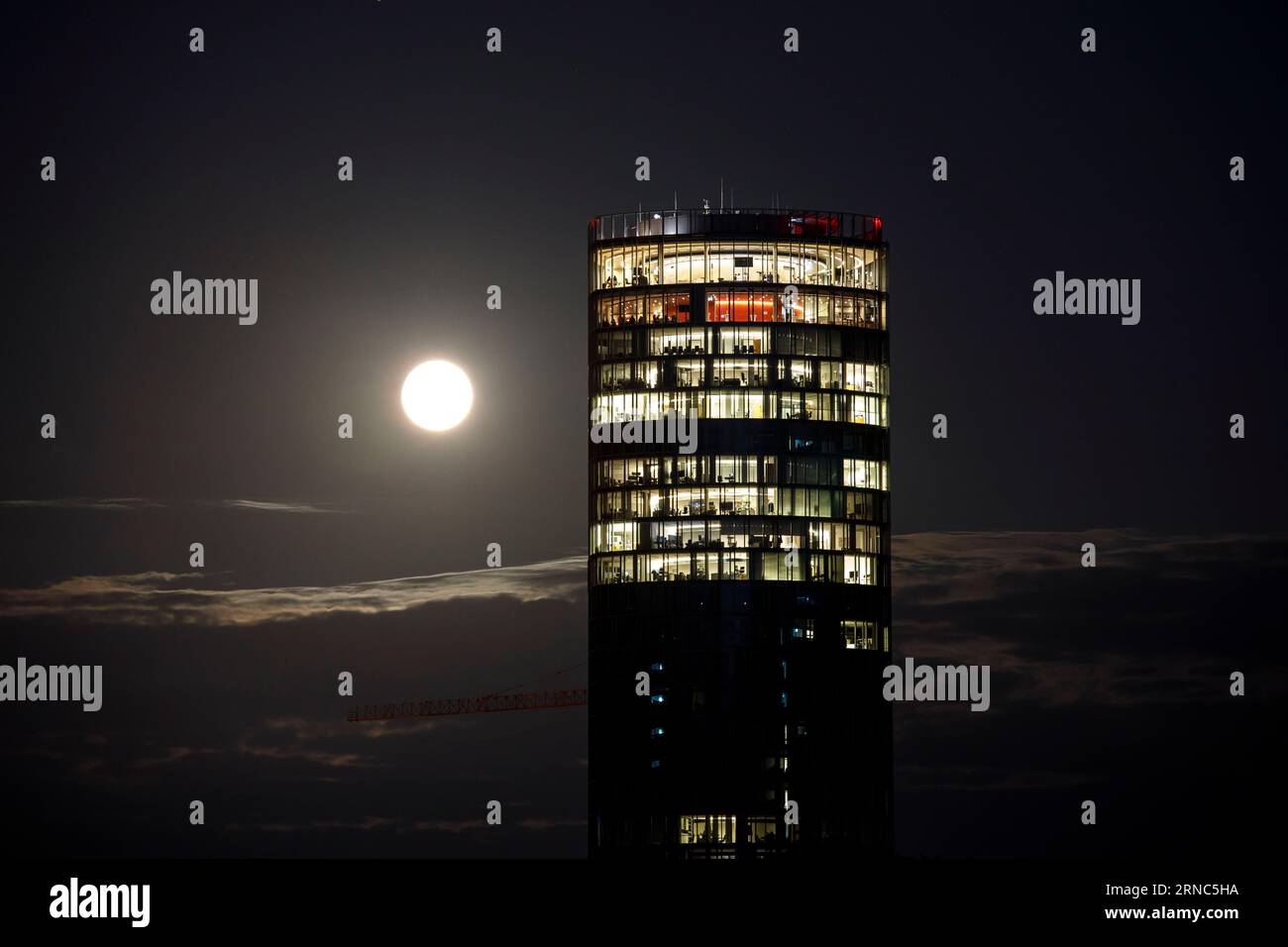 supermoon on 31.08.2023, blue moon at the sky above the district of Deutz, view across the river Rhine to the Cologne Triangle Tower, Cologne, Germany Stock Photo