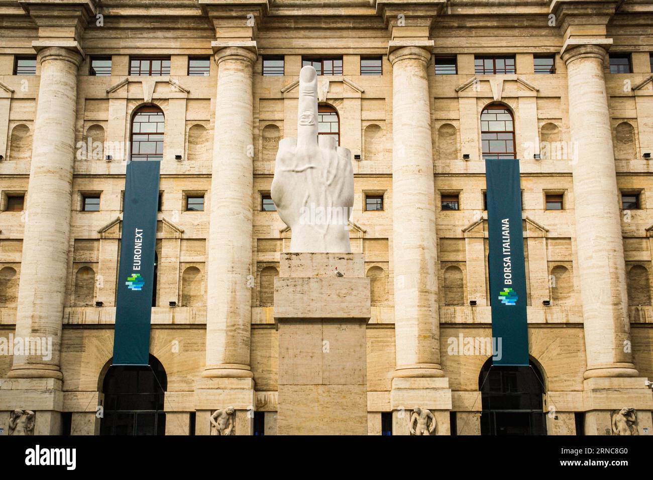 Facade of the Italian stock exchange with the finger sculpture L.O.V.E. and the EURONEXT brand (Borsa Italiana - Palazzo Mezzanotte) - HQ wide shot Stock Photo