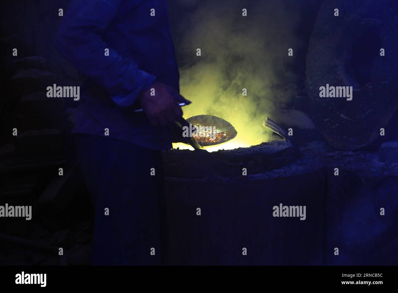 ALEXANDRIA, -- A worker melts scrap metal inside the furnace at a scrap ...