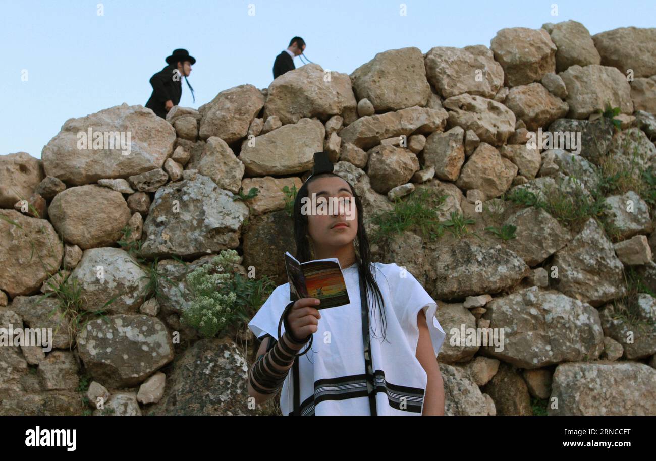(160404) -- JERUSALEM, April 4, 2016 -- Ultra-Orthodox Jews pray before they collect water from a mountain spring near Jerusalem to be used in baking unleavened bread, known as matzoth, during the Maim Shelanu (Rested Water) ceremony on April 4, 2016. Religious Jews throughout the world eat matzoth during the eight-day Pesach holiday (Passover), which begins on April 22, with the sunset to commemorate the Israelis exodus from Egypt some 3,500 years ago and commemorate their ancestors plight by refraining from eating leavened food products. ) MIDEAST-JERUSALEM-PASSOVER PREPARATION GilxCohenxMag Stock Photo